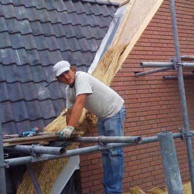 Thatched roof making. The main activity is carpentry and thatched roofing.